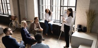 A woman presenting to a group of employees - Training Magazine