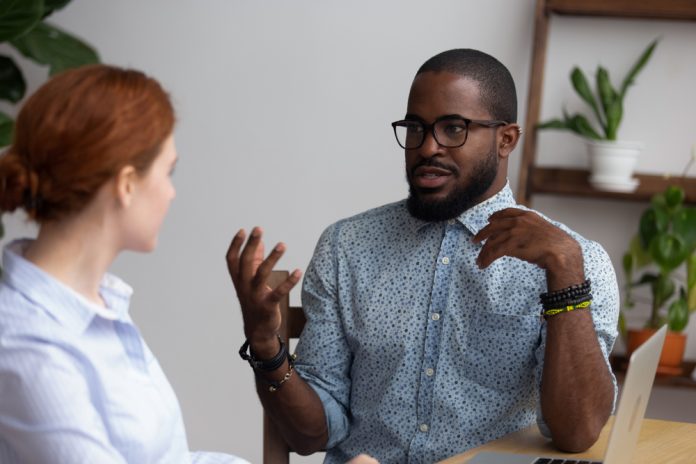 A man and a woman discussing a serious topic.