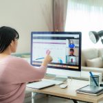 woman sitting in front of a computer working from home.