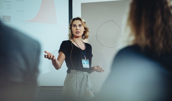 Woman,Presenting,Her,Idea,To,Colleagues,In,Meeting.,Businesswoman,Public