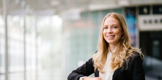 A,Russian,Woman,In,A,Suit,Leans,Against,A,Stone