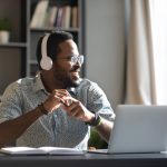 Happy,Relaxed,Millennial,Afro,American,Business,Man,Wear,Wireless,Headphones