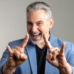 Photo of Josh Cavalier holding up both hands