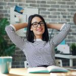 Woman sitting back in a desk chair