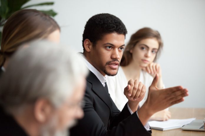 Serious,African,American,Ceo,Giving,Instructions,At,Diverse,Team,Meeting,