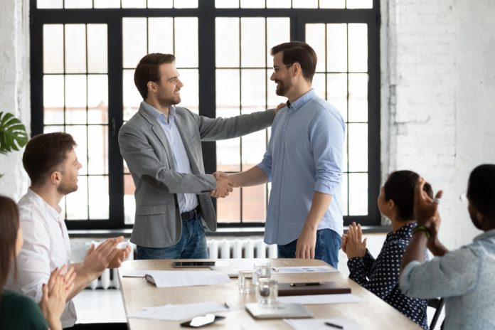Smiling,Executive,Shaking,Successful,Employee,Hand,,Congratulating,With,Job,Promotion,