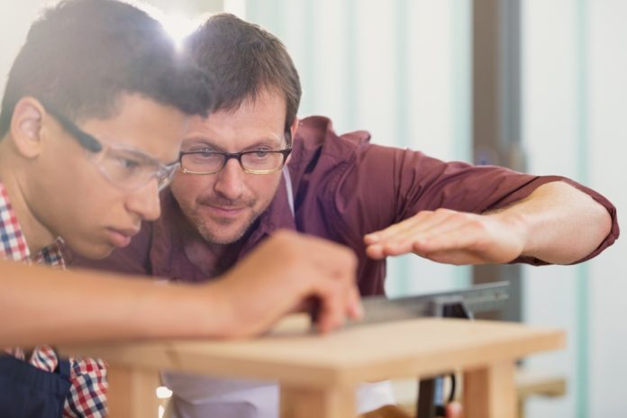 Carpentry,Teacher,And,Student,Examining,Measurement