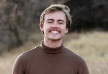 Photo of Ethan Webb with moustache and wearing brown turtleneck