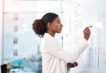 a woman standing in front of the whiteboard.