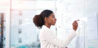 a woman standing in front of the whiteboard.
