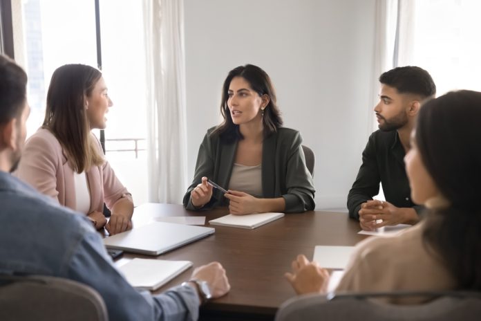Professionals,Seated,Around,Conference,Table,,Engaged,In,Meeting,Or,Discussion.