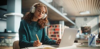 Concentrated,Young,Female,Student,Engaged,In,Academic,Research,With,Laptop