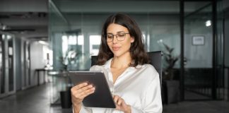 a woman at work looking at an Ipad