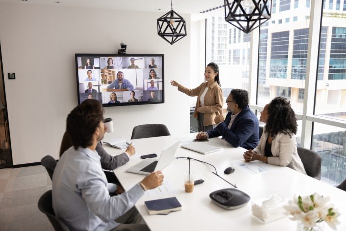 Diverse,Group,Of,Company,Employees,Talking,To,Remote,Colleagues,On