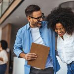 two colleagues laughing with each other.