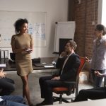 Mixed,Race,Ceo,Standing,In,Front,To,Employees,At,Coworking