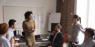 Mixed,Race,Ceo,Standing,In,Front,To,Employees,At,Coworking