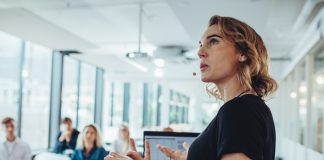 Businesswoman,Delivering,A,Presentation,At,A,Conference.,Female,Entrepreneur,Sharing