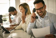 group of people working in an office handling phone calls