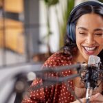 Cheerful,Young,Woman,Recording,Podcast,In,Studio,With,Copy,Space.