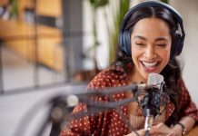 Cheerful,Young,Woman,Recording,Podcast,In,Studio,With,Copy,Space.