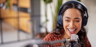 Cheerful,Young,Woman,Recording,Podcast,In,Studio,With,Copy,Space.