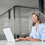 5 Ways to Protect Your Bottom Line in the Age of AI Happy,Senior,Older,Woman,Professional,Call,Contact,Center,Agent,Wearing