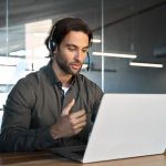 Busy,Male,Support,Service,Operator,Talking,To,Customer,Sitting,At