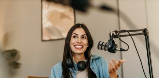Confident,Latin,Woman,With,Headphones,And,Microphone,Recording,A,Podcast
