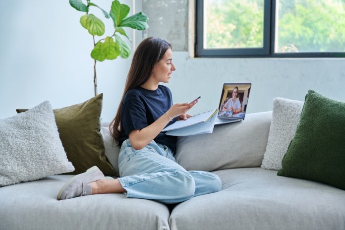 Teenage,Girl,Having,Online,Therapy,Sitting,At,Home,Using,Laptop