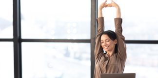 Good,Morning.,Happy,Female,Manager,Stretching,Her,Body,And,Arms