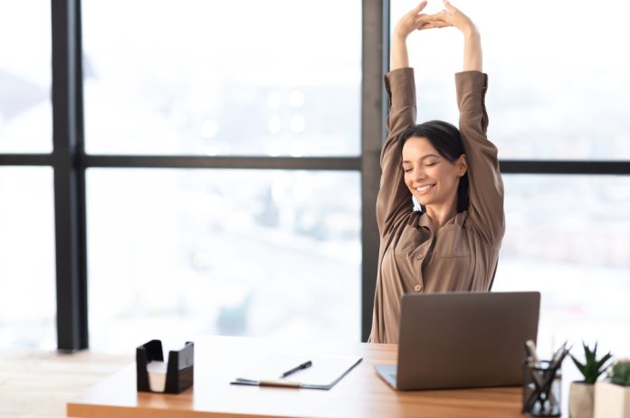 Good,Morning.,Happy,Female,Manager,Stretching,Her,Body,And,Arms
