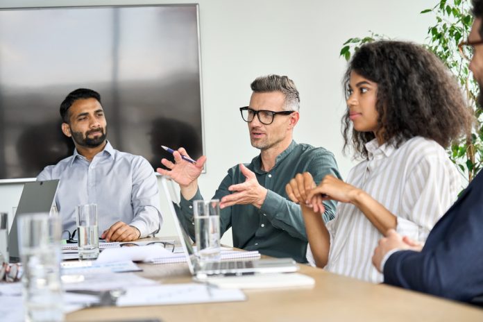 Mature,Mentor,Manager,Speaking,At,Executive,Team,Meeting,In,Boardroom. Explore the concept of institutional memory and its impact on organizational culture during digital transformations.