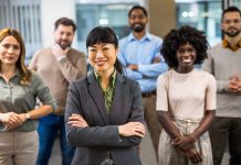 Asian,Boss,Standing,In,Front,Of,Her,Colleagues,In,The
