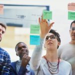 Team,,Female,Speaker,And,Sticky,Notes,On,Glass,For,Timeline,