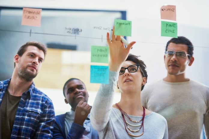 Team,,Female,Speaker,And,Sticky,Notes,On,Glass,For,Timeline,