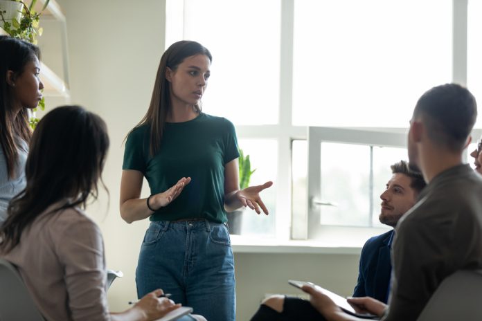 Serious,Female,Young,Business,Coach,,Team,Leader,Speaking,Before,Group, Explore impactful training strategies to become an agile leader and uplift your team through constant change and pressure.
