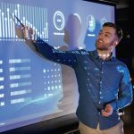 The Key to Closing Construction Workforce Gaps Statistics,On,The,Screen.,Business,Coach,Against,Projector,With,Data.