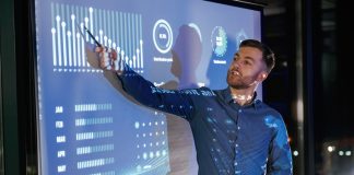 Statistics,On,The,Screen.,Business,Coach,Against,Projector,With,Data.