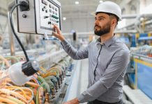 Industrial,Engineer,Wearing,Hardhat,Operating,Control,Panel,Of,Machinery,In