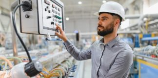Industrial,Engineer,Wearing,Hardhat,Operating,Control,Panel,Of,Machinery,In