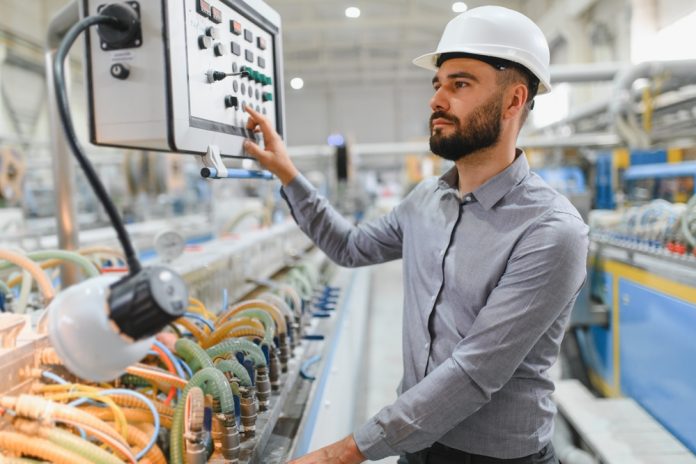 Industrial,Engineer,Wearing,Hardhat,Operating,Control,Panel,Of,Machinery,In